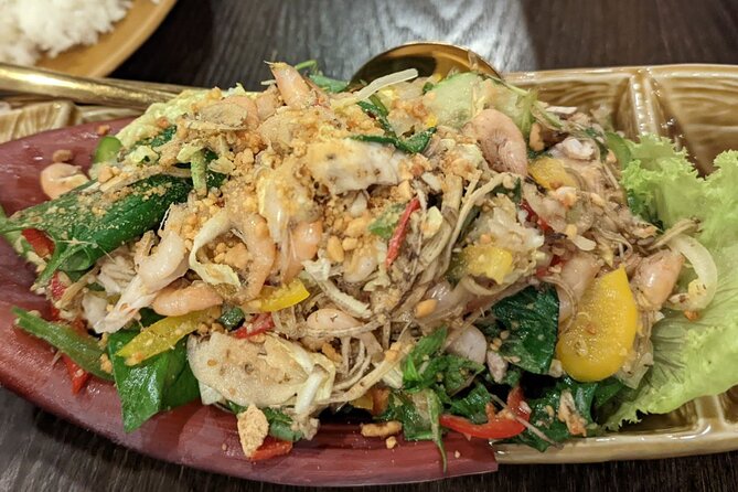 Phnom Penh Authentic Evening Food Tour 100% By Local - Stop 2: Wat Botum Park noodles, edible flowers, and fermented pickles