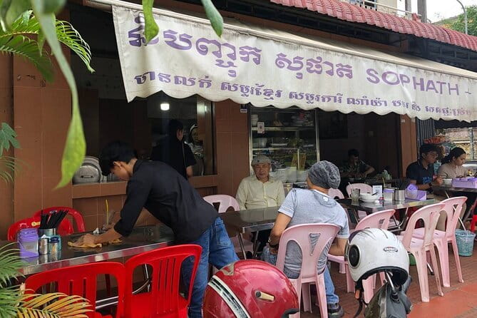 Phnom Penh Night City Highlights & Local Food tour by Tuktuk - Royal Palace at night: golden spires, softer light, and calmer gardens